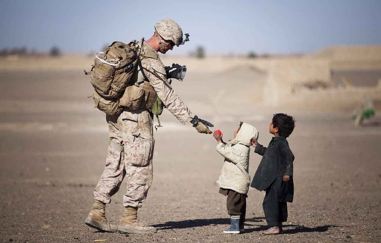 Military soldier playing with kids