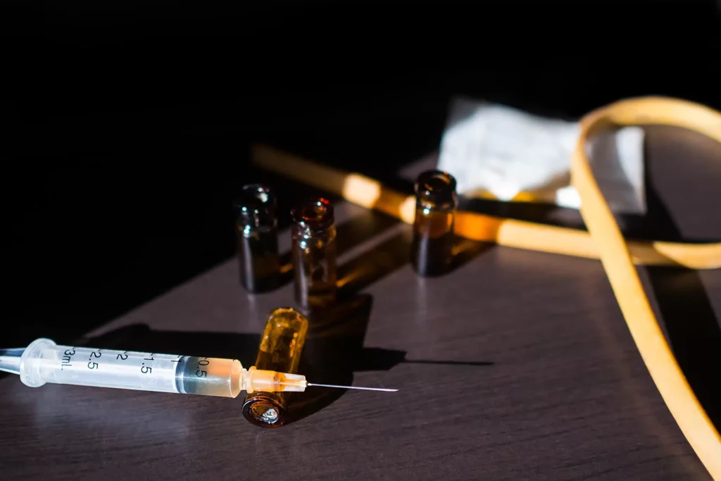 a syringe and vials on a table